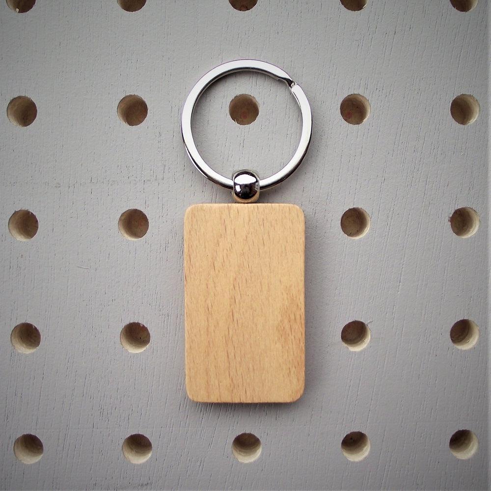 Personalised 'Never Give Up' Wooden Keyring (rectangular fob) made for you by Custom Gift Studio at Cheshire Oaks